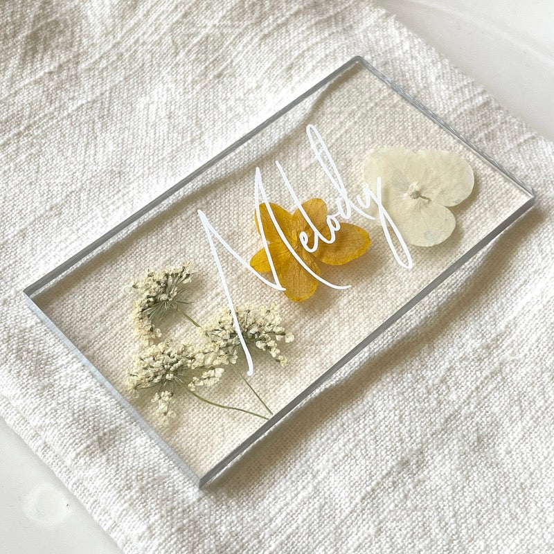 pressed yellow hydrangea wedding place card on napkin