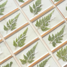 Load image into Gallery viewer, numerous pressed fern wedding place cards with gold lining
